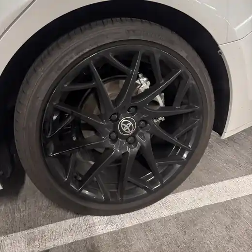 Dirty wheel covered in brake dust before cleaning